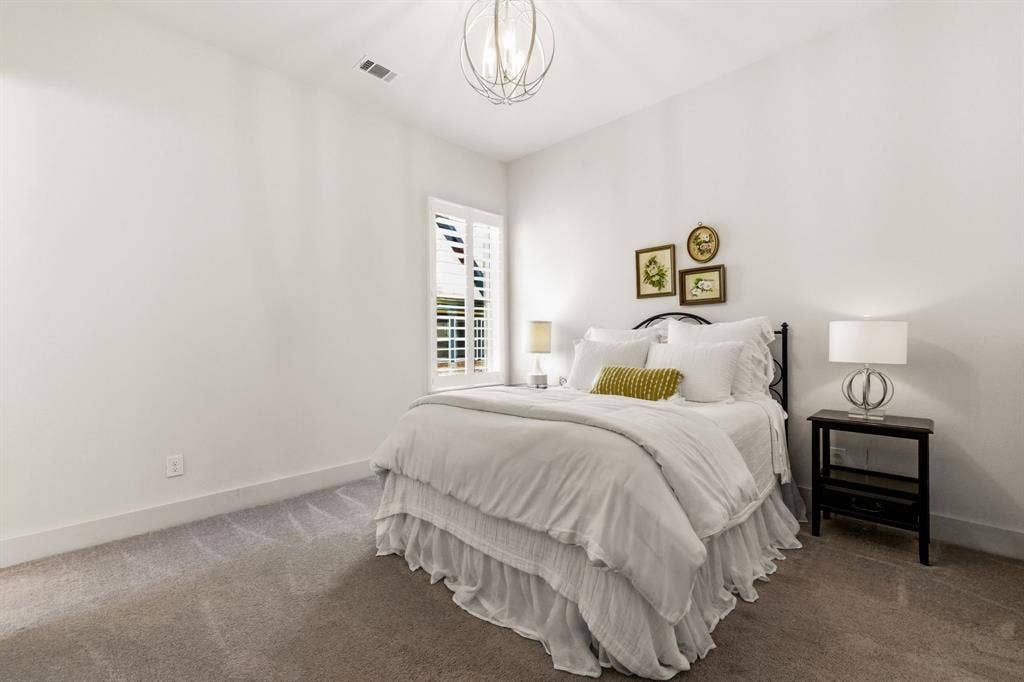 404 Travelers Terrace, Argyle, TX 76226 Guest bedroom with ensuite bath is split from all of the other bedrooms which offers privacy for your overnight guests. There is an impressive designer chandelier in this room.