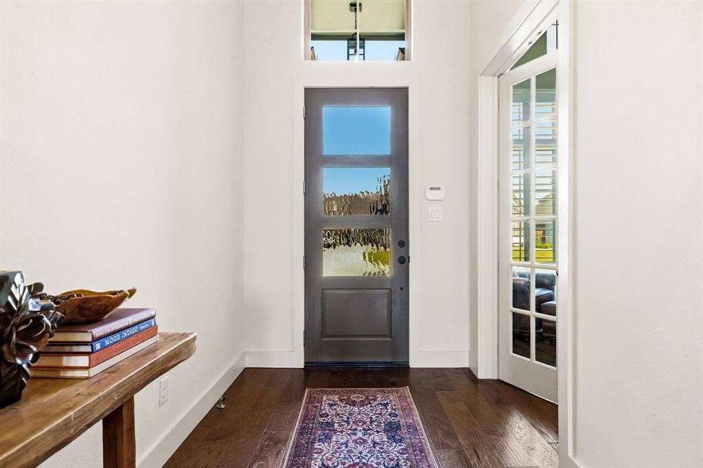 404 Travelers Terrace, Argyle, TX 76226 The wood and glass front door lets the natural light shine in.