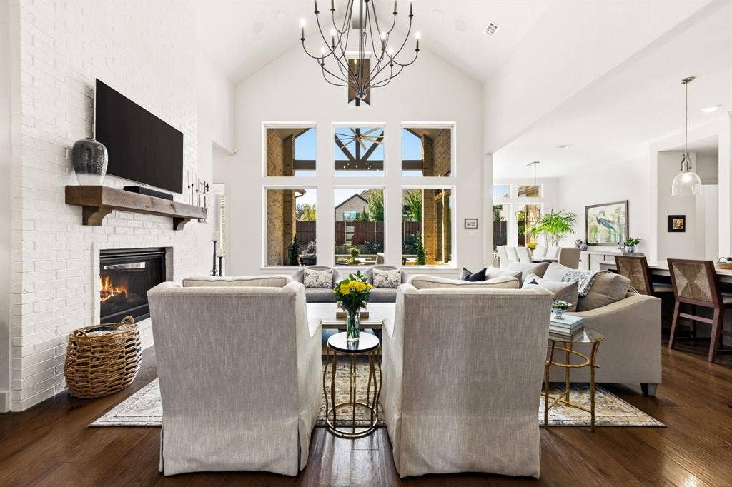 404 Travelers Terrace, Argyle, TX 76226 The chandelier in the living room is a show-stopper. Notice the engineered hickory wood floors!