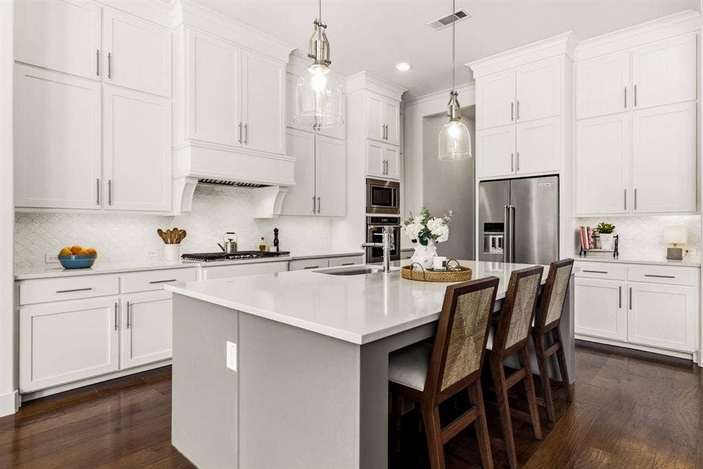 404 Travelers Terrace, Argyle, TX 76226 The kitchen features quartz countertops & a farm sink in the island.
