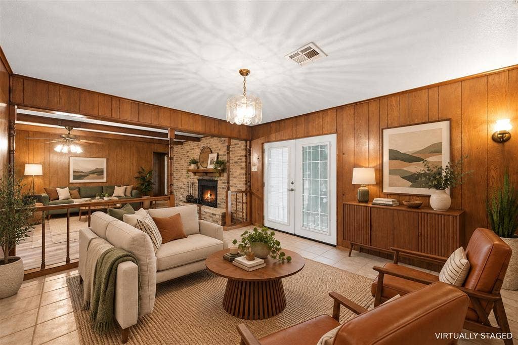 Wood-paneled walls with an exposed brick fireplace