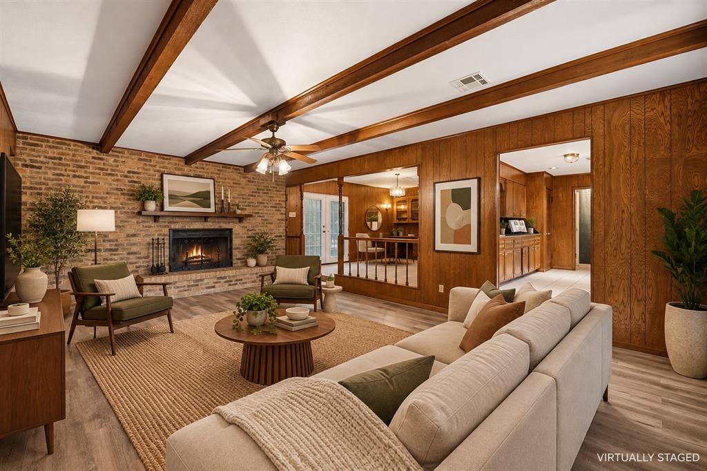 Exposed wood beam ceiling, brick fireplace with mantel, wood paneling, wood-finish flooring, and ceiling fan
