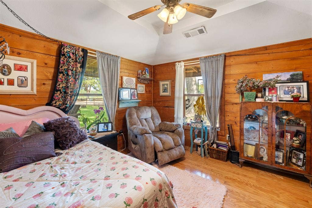 13494 County Road 2919, Eustace, TX 75124 Room with wood-finish paneling, wood-finish flooring, and a vaulted ceiling