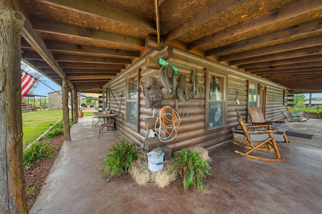 13494 County Road 2919, Eustace, TX 75124 Expansive wrap-around porch featuring a stained concrete floor and natural wood posts