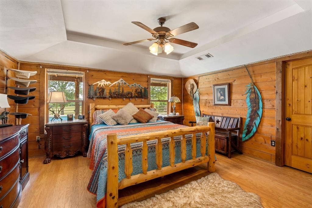 13494 County Road 2919, Eustace, TX 75124 Bedroom featuring wood-finish flooring and extensive wood paneling