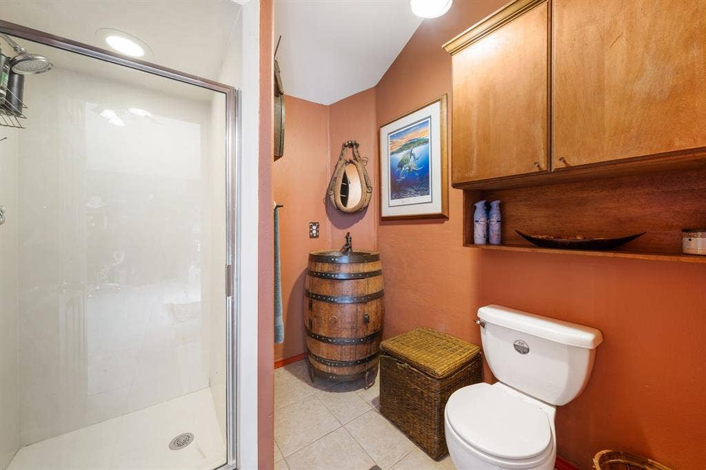 13494 County Road 2919, Eustace, TX 75124 Bathroom featuring a stand-up shower with a glass enclosure, tiled flooring, wood cabinetry with open shelving, a toilet, and a barrel-style vanity