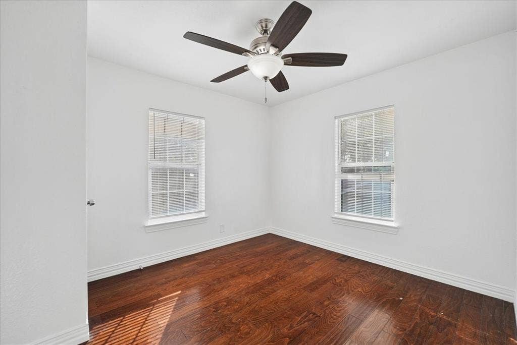 Hardwood flooring with a ceiling fan light fixture