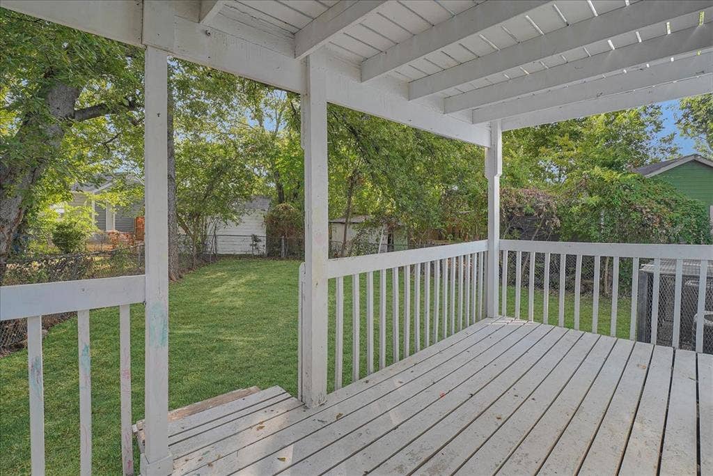 Covered patio with painted wood decking and railings