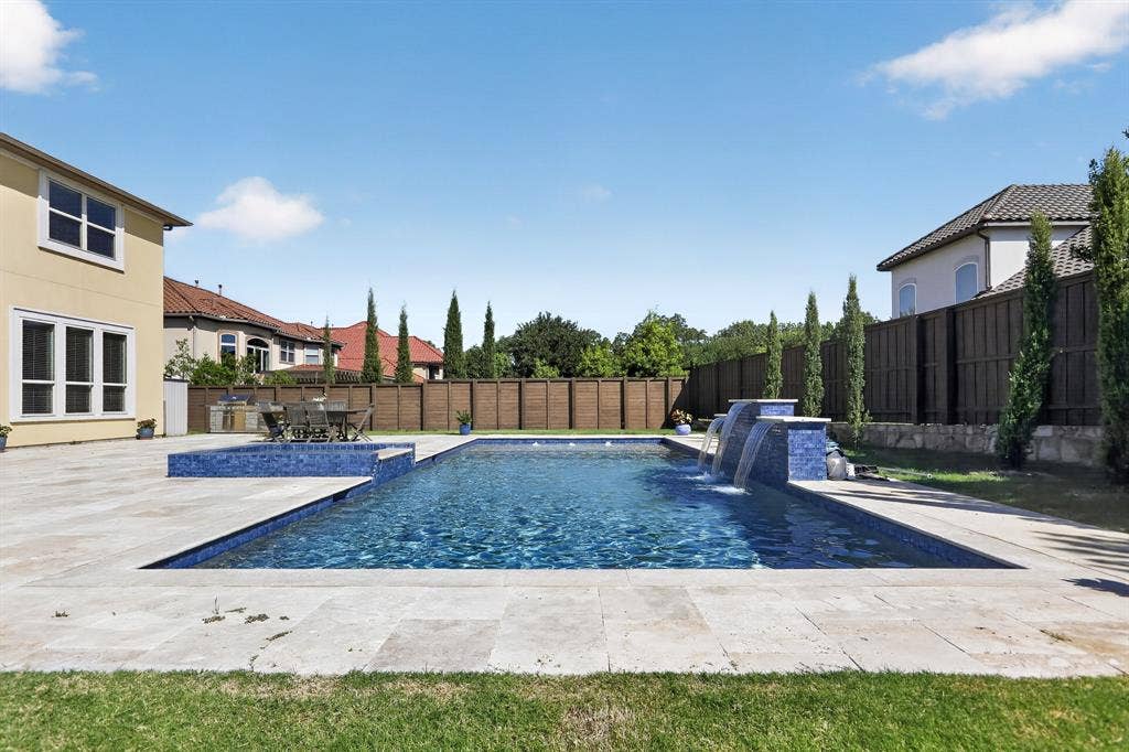 12226 Lazio Lane, Frisco, TX 75035 Expansive backyard featuring a rectangular swimming pool with integrated water features and a spa