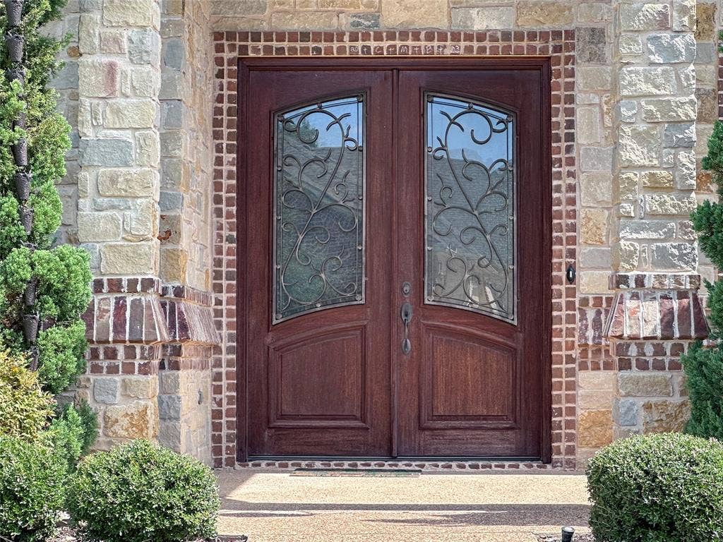 1100 Wessex Drive, Woodway, TX 76712 Double-door entry featuring decorative glass inserts with wrought iron detailing