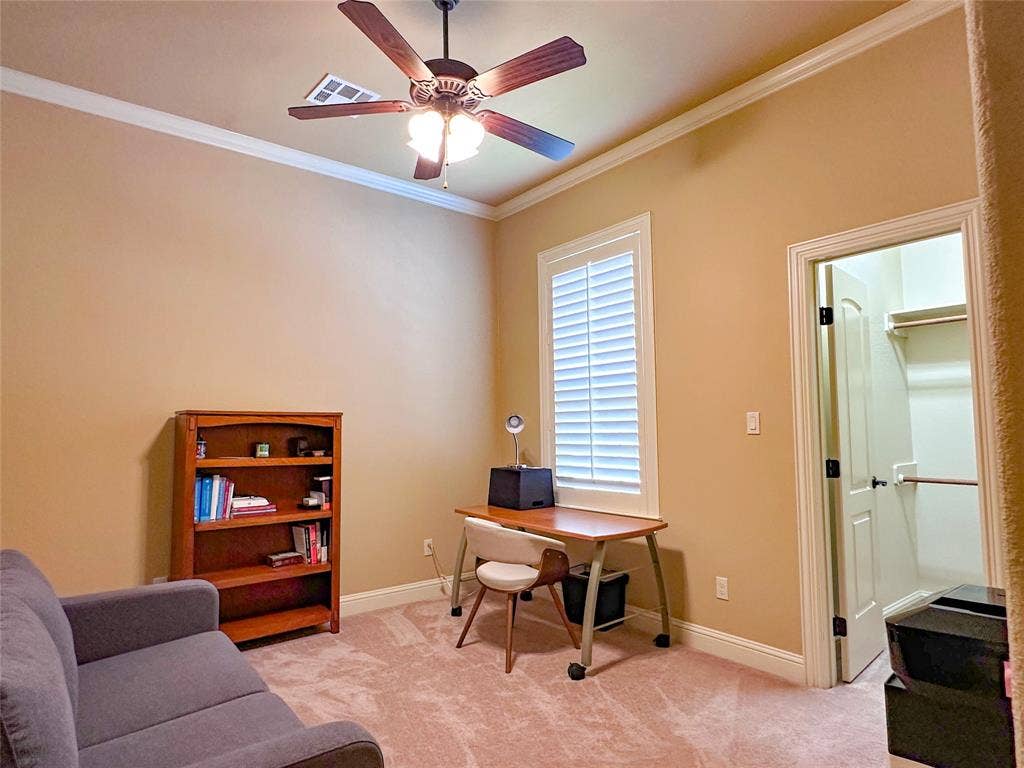 1100 Wessex Drive, Woodway, TX 76712 Spacious room with high ceilings and crown molding, featuring a ceiling fan, plush carpeting, and a window with plantation shutters