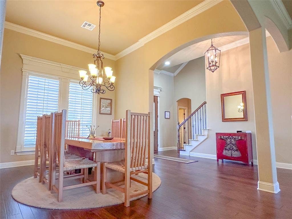 1100 Wessex Drive, Woodway, TX 76712 Formal dining area featuring rich wood-finish flooring, crown molding, and a chandelier