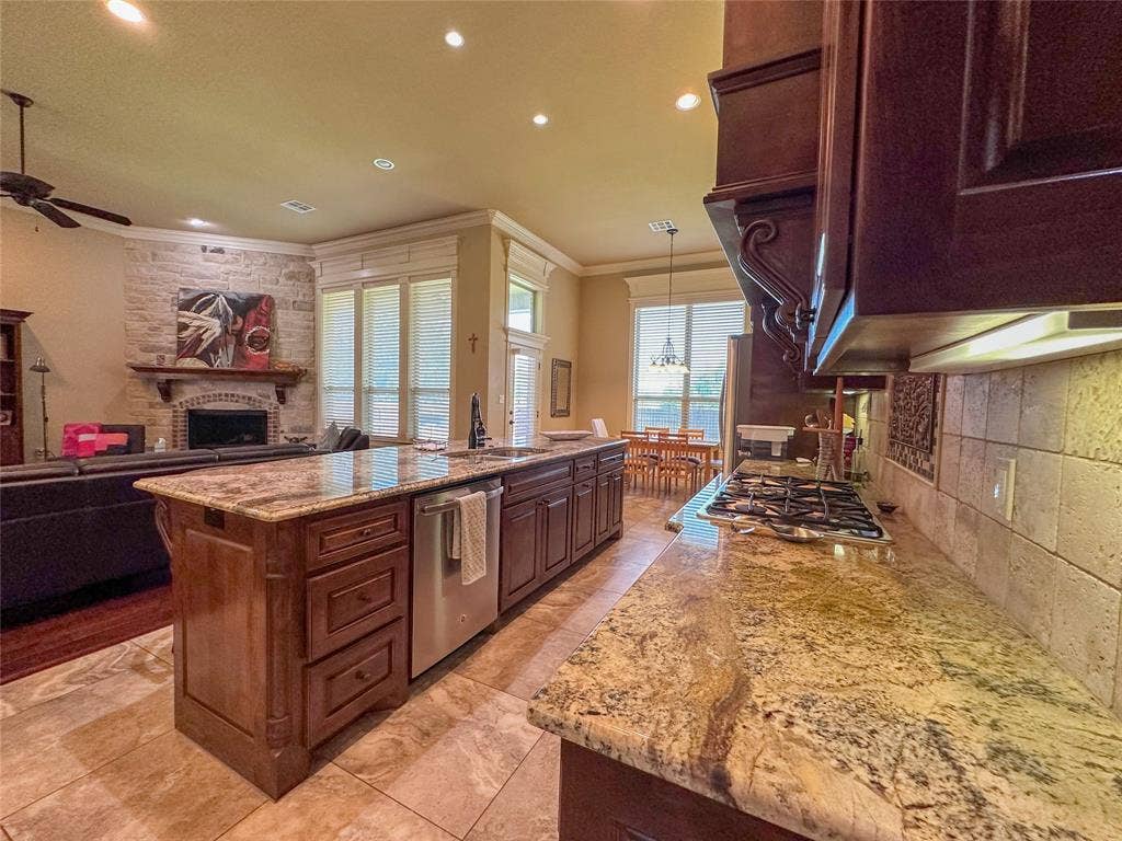 1100 Wessex Drive, Woodway, TX 76712 Kitchen featuring granite countertops, wood cabinetry, built-in gas range, and a tiled backsplash