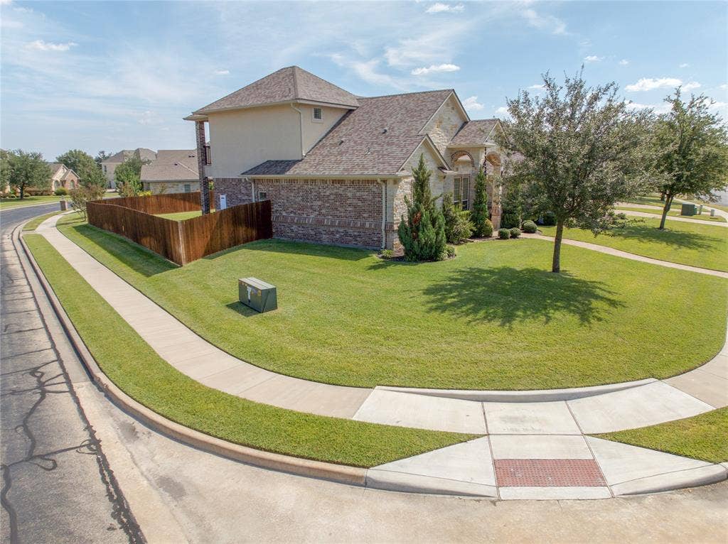 1100 Wessex Drive, Woodway, TX 76712 Stone and brick exterior with a multi-level roofline