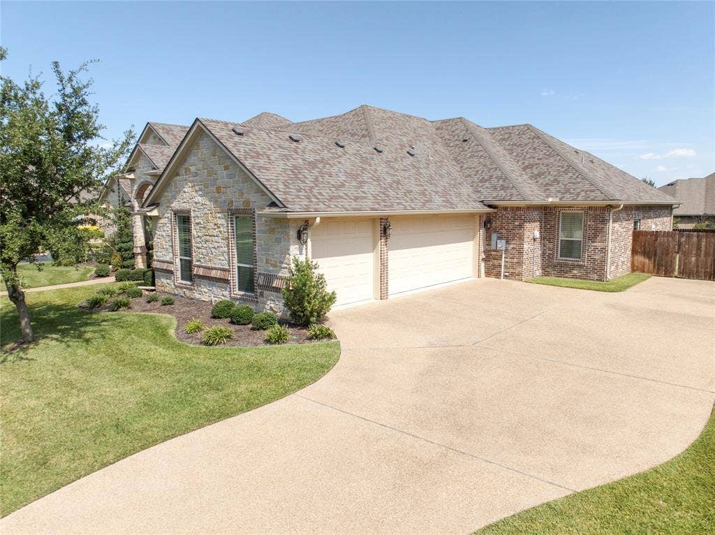 1100 Wessex Drive, Woodway, TX 76712 Stone and brick facade with a two-car garage