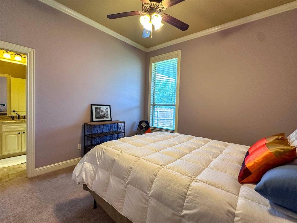 1100 Wessex Drive, Woodway, TX 76712 Bedroom featuring a ceiling fan with integrated lighting, crown molding, and a window with blinds
