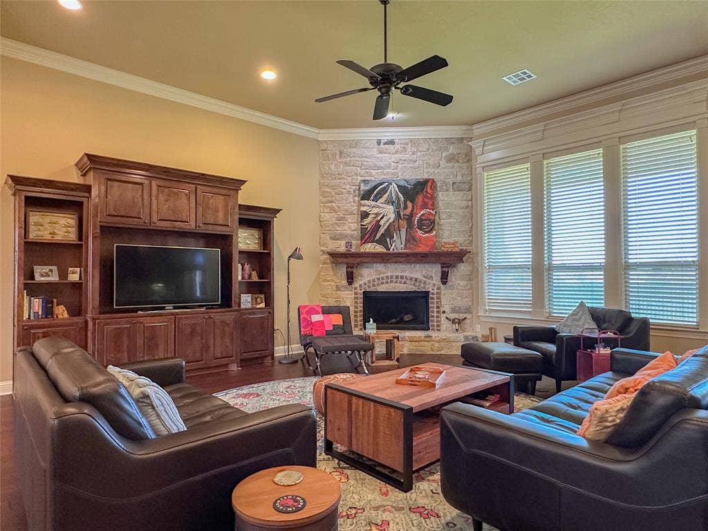 1100 Wessex Drive, Woodway, TX 76712 Living area with a stone-clad fireplace and wood mantel