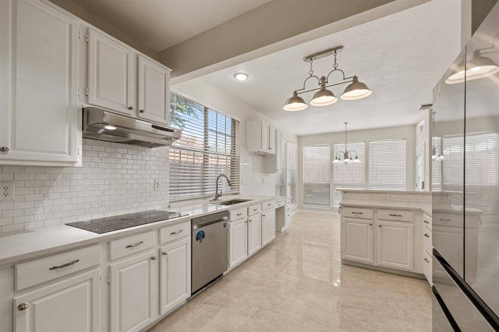 669 Water Oak Drive, Plano, TX 75025 Kitchen featuring white shaker-style cabinetry, a white subway tile backsplash, and light-toned tile flooring