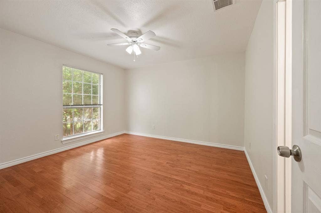 669 Water Oak Drive, Plano, TX 75025 Room featuring wood-finish flooring, a multi-pane window, and a ceiling fan with integrated lighting