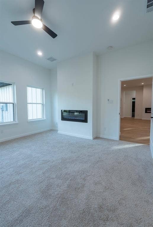 3315 Kyser, Dallas, TX 75216 Spacious room featuring plush carpeting, an integrated linear fireplace, and abundant natural light from multiple windows