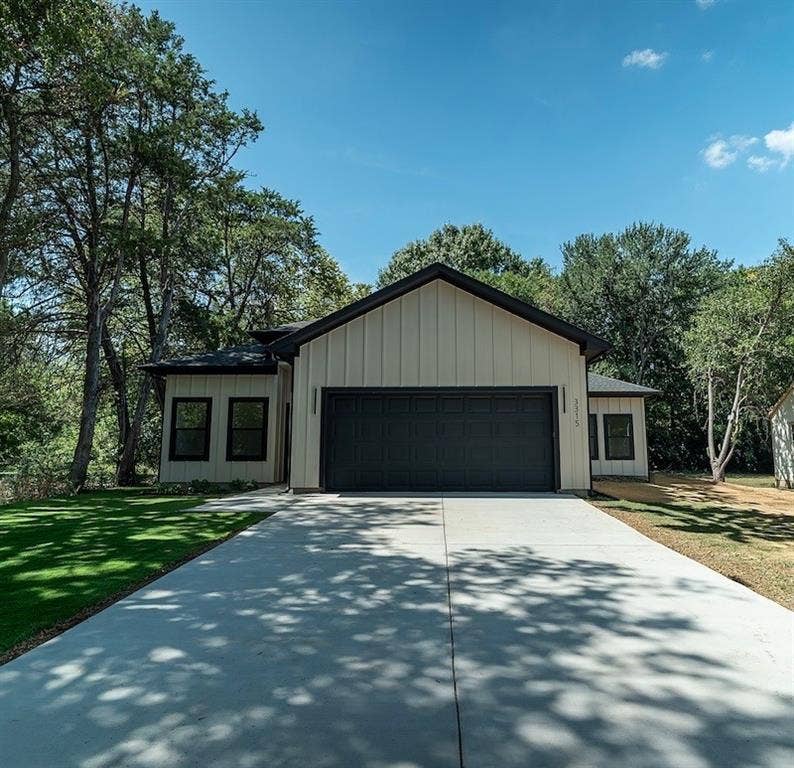 3315 Kyser, Dallas, TX 75216 Modern farmhouse-style exterior featuring vertical panel siding, a dark-toned garage door, and a black-trimmed roofline