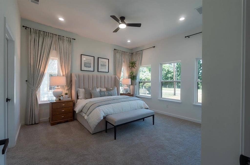 3315 Kyser, Dallas, TX 75216 Carpeted bedroom featuring an upholstered headboard, a ceiling fan with integrated lighting, recessed lighting, and multiple windows with curtain rods