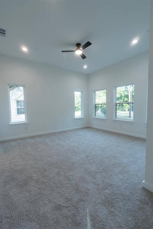 3315 Kyser, Dallas, TX 75216 Spacious room featuring neutral carpeting, white walls, multiple windows, a ceiling fan, and recessed lighting