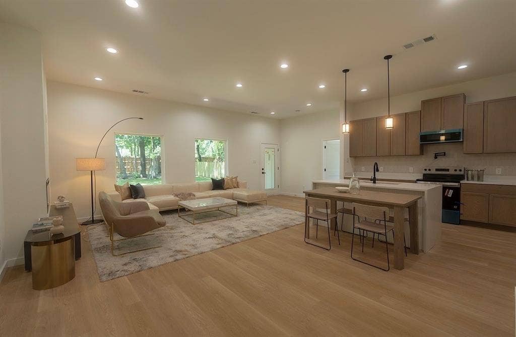 3315 Kyser, Dallas, TX 75216 Open-concept living space featuring wood-finish flooring, recessed lighting, and large windows