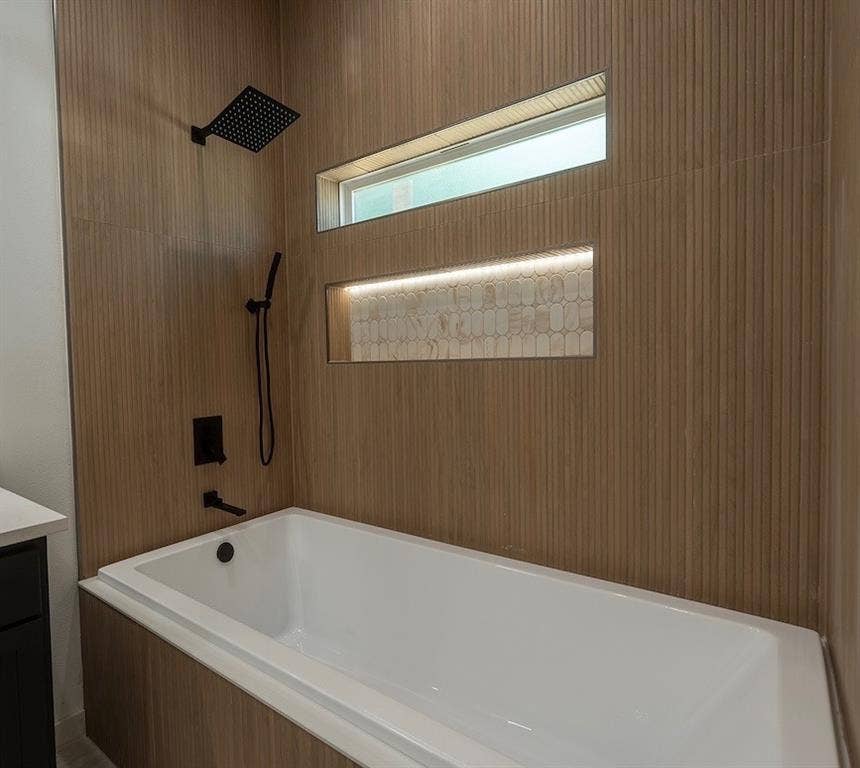 3315 Kyser, Dallas, TX 75216 Built-in bathtub with matte black fixtures and a rainfall showerhead