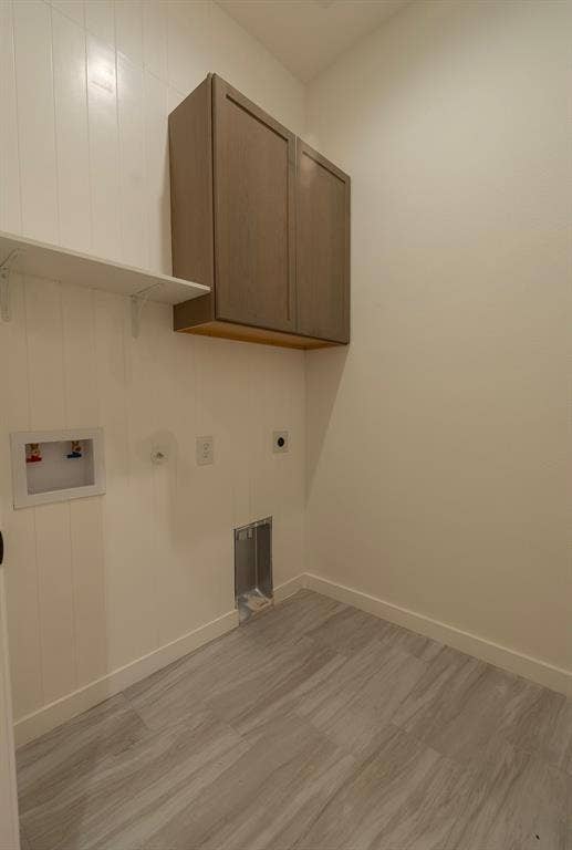 3315 Kyser, Dallas, TX 75216 Utility room featuring wood-finish cabinetry, white shiplap wall paneling, a white shelf, and light wood-finish flooring