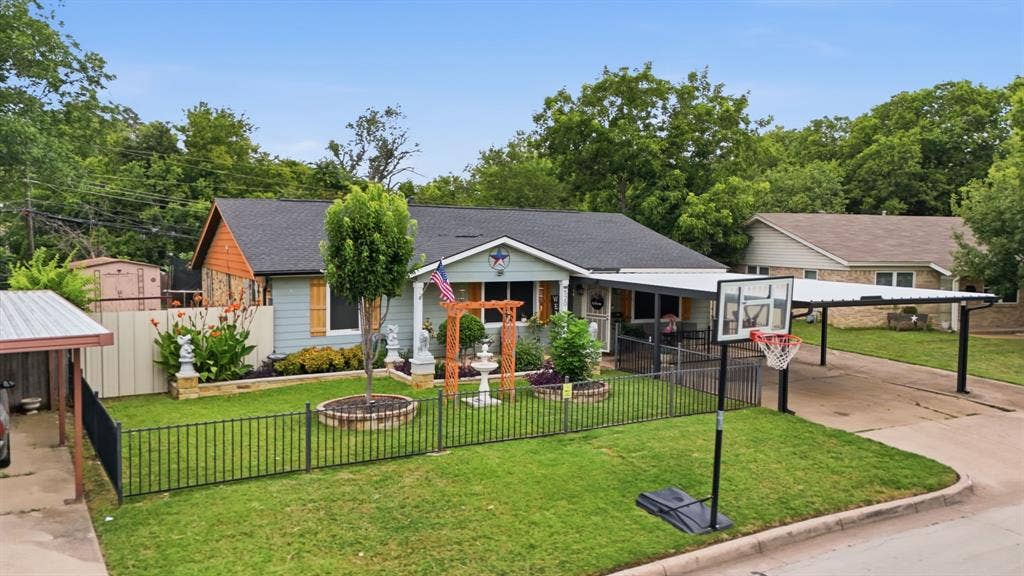 520 Thompson Drive, Saginaw, TX 76179 Ranch-style residence featuring a pale blue exterior with natural stone accents and a covered front porch