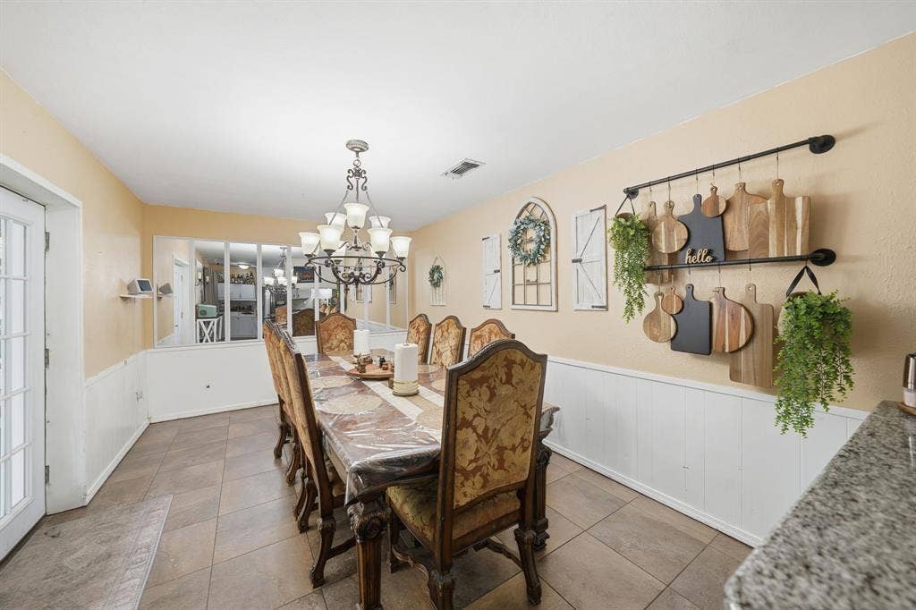 520 Thompson Drive, Saginaw, TX 76179 Spacious dining area featuring neutral-toned walls, tile flooring, and white wainscoting