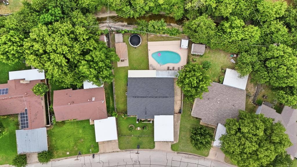 520 Thompson Drive, Saginaw, TX 76179 Aerial perspective of a property featuring a central residence with a dark shingle roof