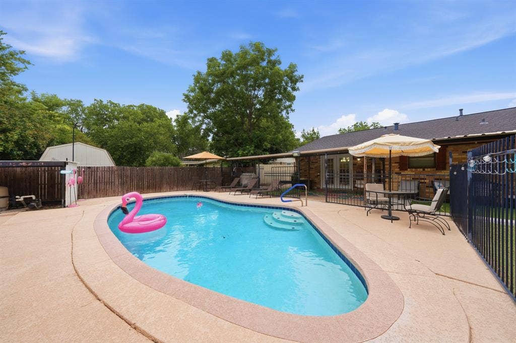 520 Thompson Drive, Saginaw, TX 76179 Backyard oasis featuring an in-ground swimming pool with integrated steps, surrounded by extensive concrete decking