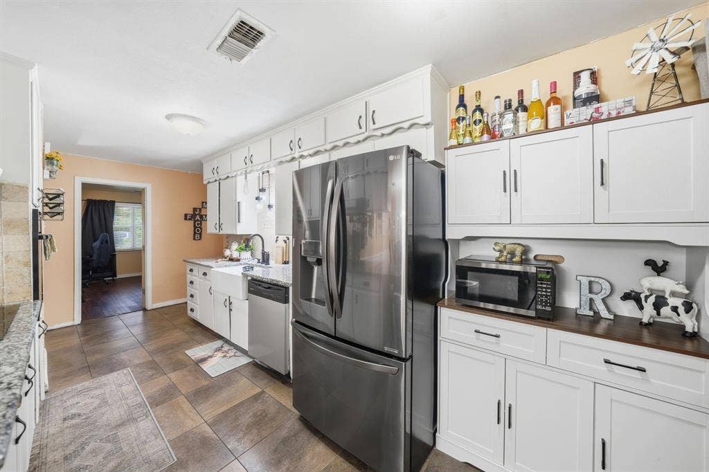520 Thompson Drive, Saginaw, TX 76179 Kitchen featuring white shaker-style cabinetry, granite countertops, and stainless steel appliances