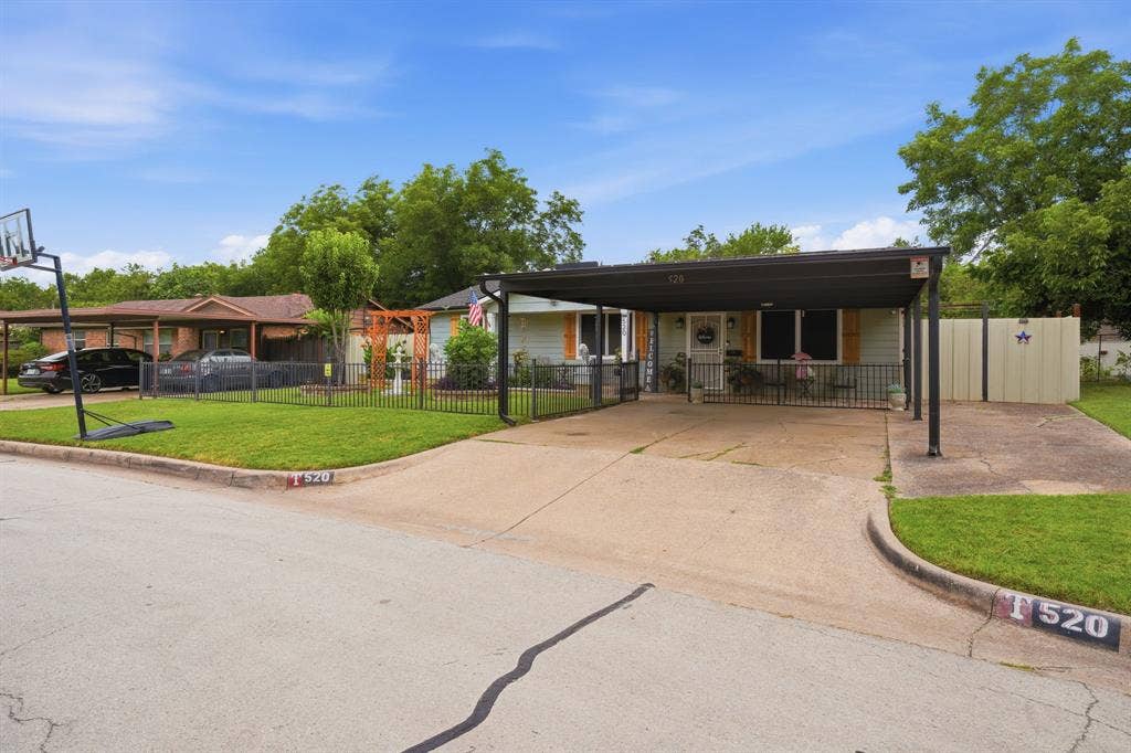 520 Thompson Drive, Saginaw, TX 76179 Corner lot residence featuring a carport, concrete driveway, and front porch