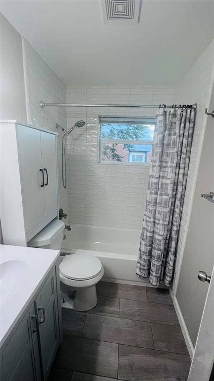 909 Laguna Drive, Denton, TX 76209 Bathroom featuring a white subway tile surround, a single window, wood-finish flooring, a white vanity with a white countertop, and a built-in storage cabinet