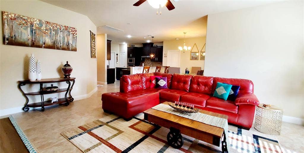 104 Rustic Oak Lane, McKinney, TX 75072 Open-concept living area featuring light-toned tile flooring, recessed lighting, and a ceiling fan