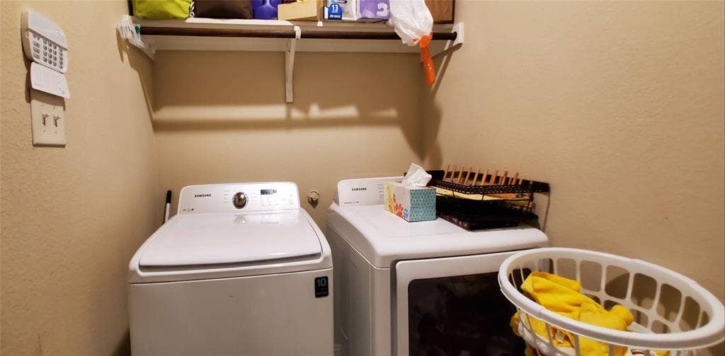 104 Rustic Oak Lane, McKinney, TX 75072 Utility area featuring a top-load washer and front-load dryer
