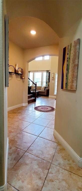 104 Rustic Oak Lane, McKinney, TX 75072 Entryway featuring large format square tile flooring and arched doorways