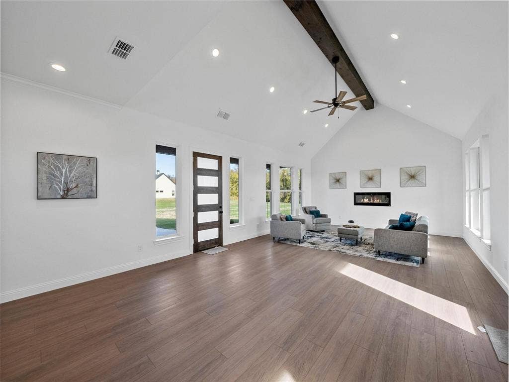 1203 Chapel Drive, Rockwall, TX 75032 Vaulted ceiling with exposed beam, wood-finish flooring, recessed lighting, linear fireplace, and ceiling fan