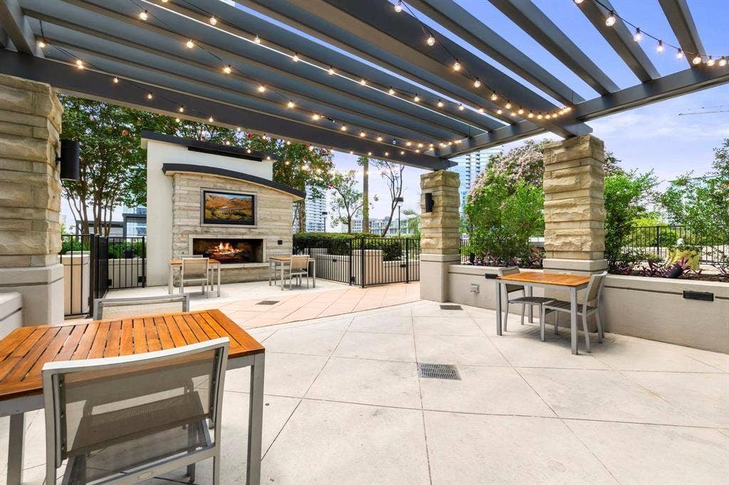 360 Nueces Street, #2110, Austin, TX 78701 Outdoor patio with an integrated fireplace and television feature
