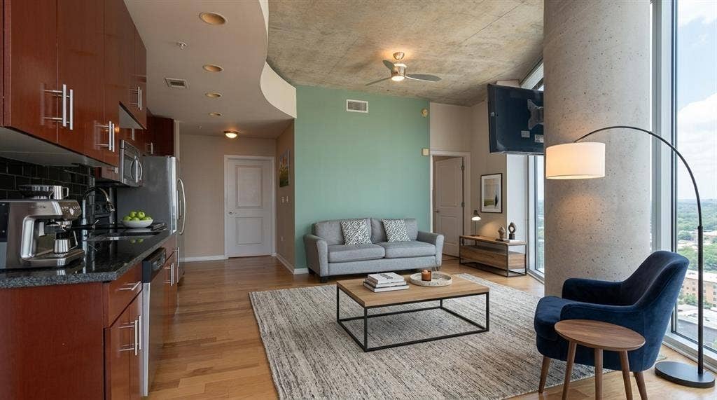 360 Nueces Street, #2110, Austin, TX 78701 Virtually Staged Open-concept living area featuring finish flooring,a contemporary kitchen with dark cabinetry and stainless steel appliances, a ceiling fan, and large floor-to-ceiling windows