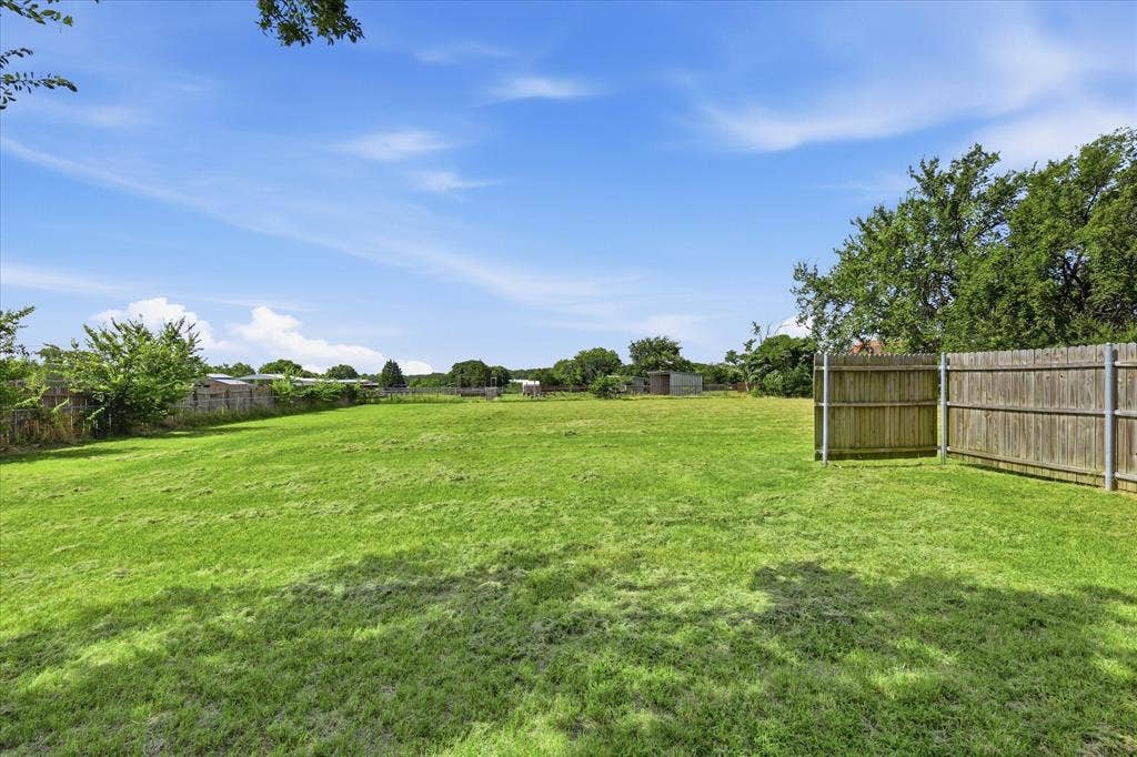 Expansive green space featuring a large, flat lawn