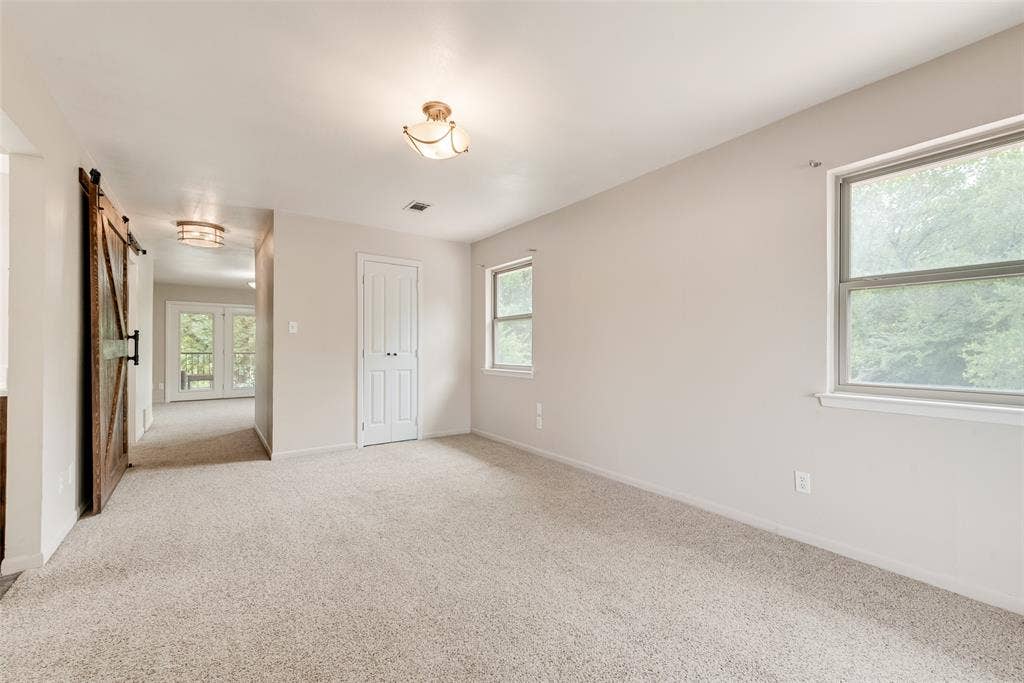 Primary room with barn doors that provide privacy from other bedrooms. Library study and balcony attached.