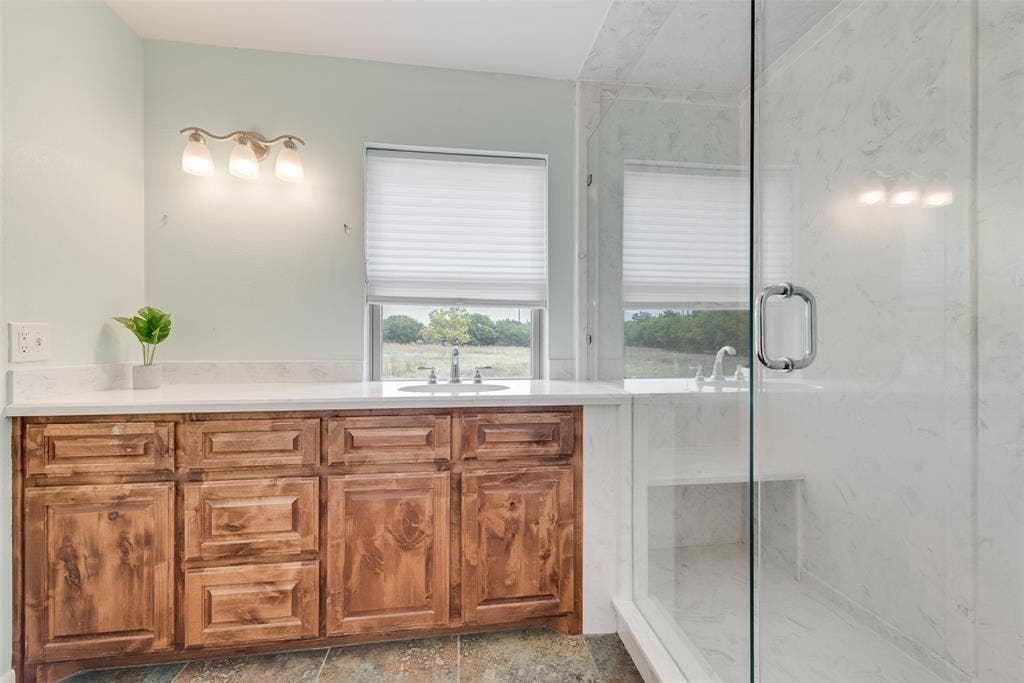 Upstairs shared bathroom with double marble shower.