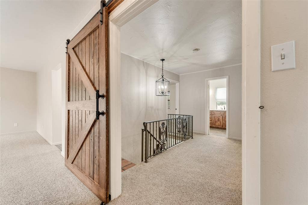 Barn doors that separate primary bedroom from other rooms upstairs