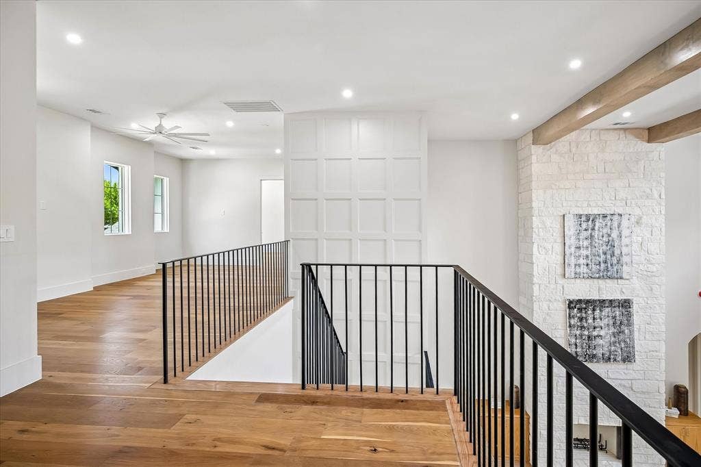 3304 Townsend Drive, Dallas, TX 75229 Second floor landing, iron railing overlook, board and batten accent wall, hardwood floors