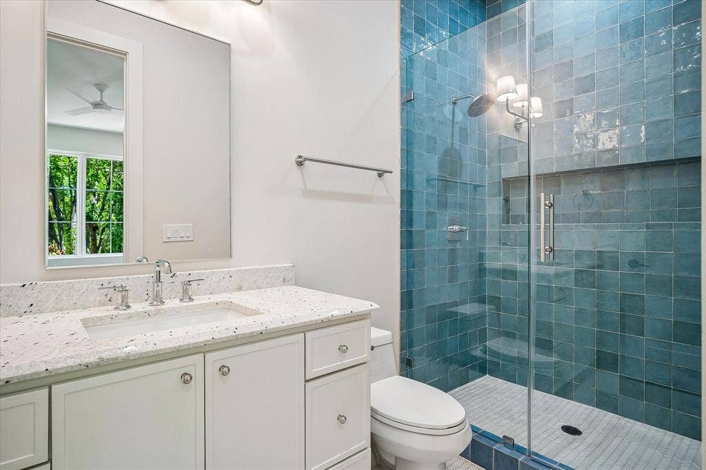 3304 Townsend Drive, Dallas, TX 75229 Bath, blue glazed tile shower, single vanity, frameless glass enclosure