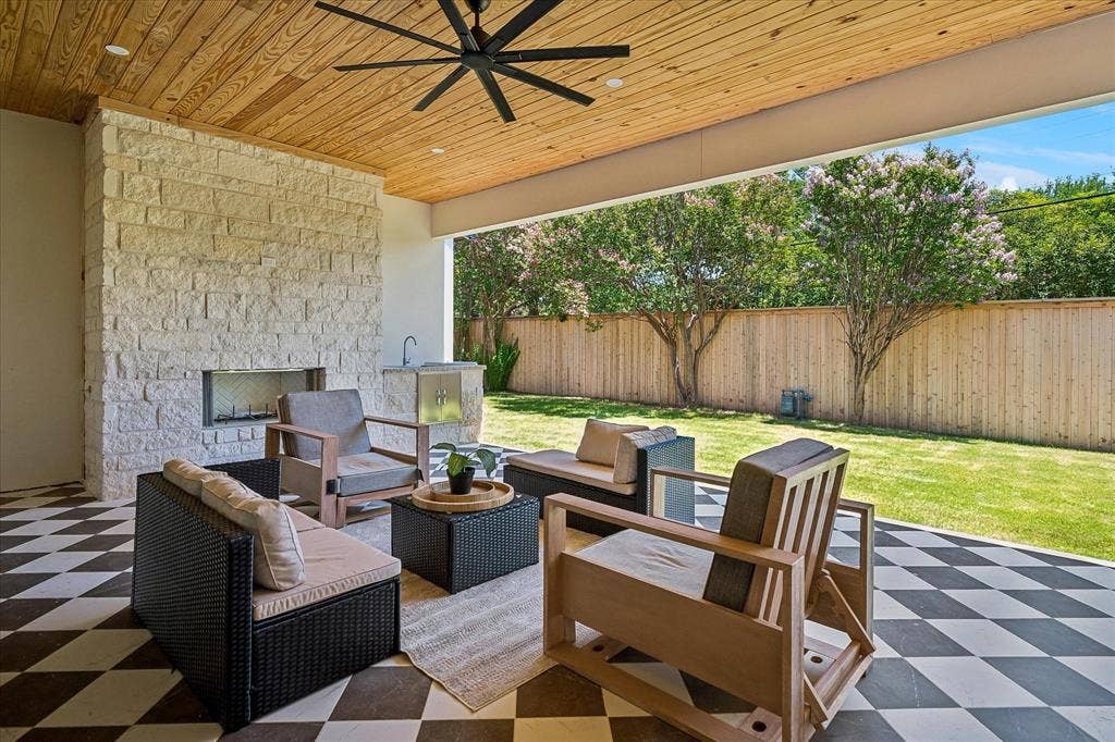 3304 Townsend Drive, Dallas, TX 75229 427 SF covered patio, stone fireplace, tongue and groove wood ceiling, ceiling fan, outdoor kitchen